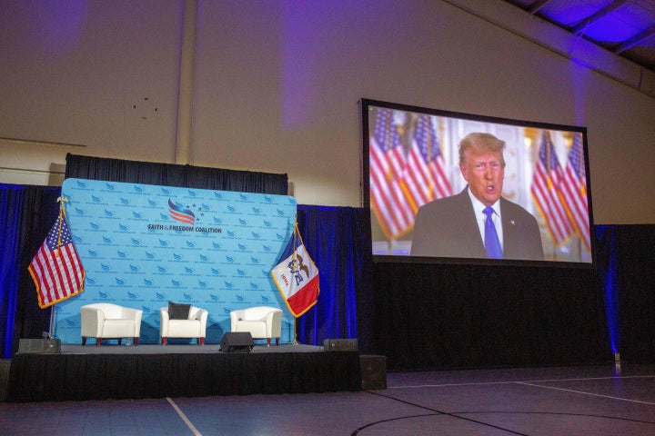 A recording of Former US President Donald Trump speaking plays on a monitor during the Iowa Faith and Freedom Coalition's Road to Victory Conference at the Horizon Events Center in Clive, Iowa, on April 22, 2023. (Photo by Rachel MUMMEY / AFP) (Photo by RACHEL MUMMEY/AFP via Getty Images)