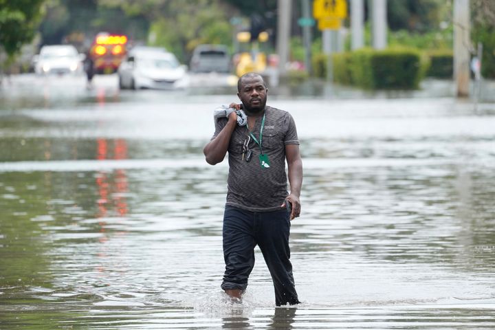A man walks out of a flooded neighborhood on April 13 in Fort Lauderdale, Florida. Florida Gov. Ron DeSantis said Saturday he is asking the Biden administration to declare Broward County a disaster area due to the flooding.