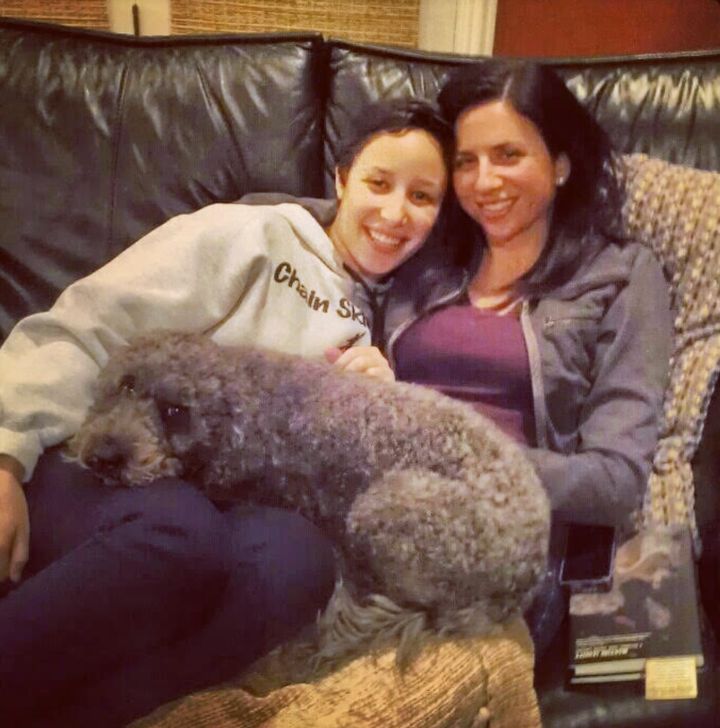 The author enjoying a snuggle on the sofa with Faith and their pup at home in Deerfield, Illinois. "This photo is from 2012, a few months after Faith's energy healing," the author writes.