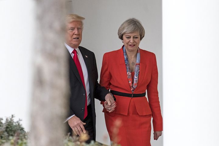 Former Prime Minister Theresa May and ex-U.S. President Donald Trump walk along The Colonnade of the West Wing at The White House on January 27, 2017 in Washington, DC.