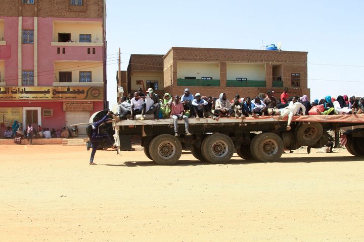 People fleeing street battles between the forces of two rival Sudanese generals, are transported on the back of a truck in the southern part of Khartoum, on April 21, 2023. 
