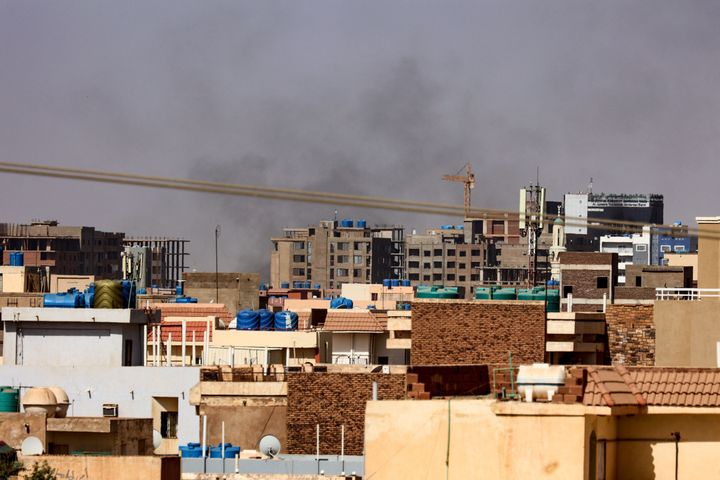 Smoke billows over residential buildings in eastern Khartoum on April 22, 2023, during ongoing battles between the forces of two rival generals.