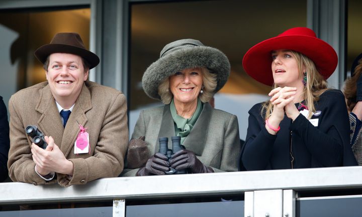 Camilla, then-Duchess of Cornwall, with her son Tom Parker Bowles (left) and daughter Laura Lopes (right) watch the racing as they attend the Cheltenham Festival on March 11, 2015. 