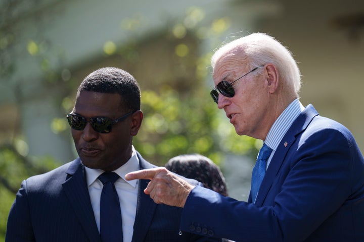 President Joe Biden talks to Environmental Protection Agency Administrator Michael Regan in the Rose Garden of the White House, April 21.