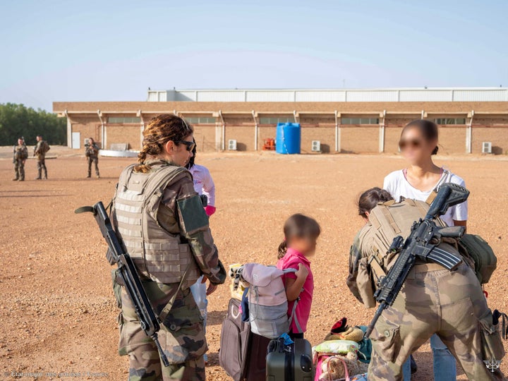 French soldiers evacuate French citizens, as part of the "Operation Sagittaire" evacuation by the French army, in Khartoum, Sudan, April 23, 2023. 