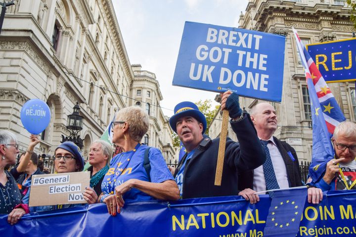 Anti-Brexit activist Steve Bray (wearing hat) holds an anti-Brexit placard during the demonstration outside Downing Street. 