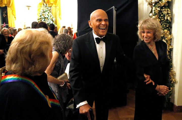 FILE PHOTO: Harry Belafonte (C) laughs with a fellow audience member as they depart after a reception for the 2013 Kennedy Center Honors recipients at the White House in Washington, December 8, 2013. REUTERS/Jonathan Ernst/File Photo