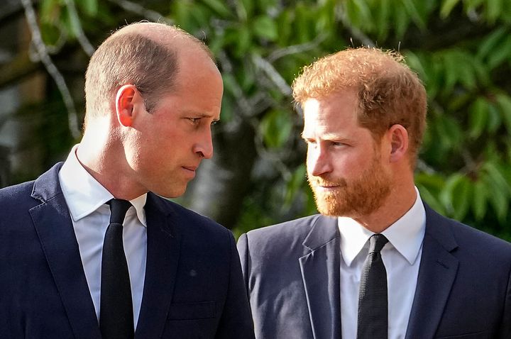 Prince William and Prince Harry walk beside each other after viewing the floral tributes for the late Queen Elizabeth II outside Windsor Castle, in Windsor in September 2022. 