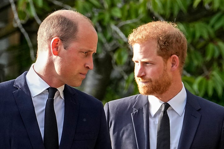 Prince William and Prince Harry walk beside each other after viewing the floral tributes for the late Queen Elizabeth II outside Windsor Castle, in Windsor in September 2022. 