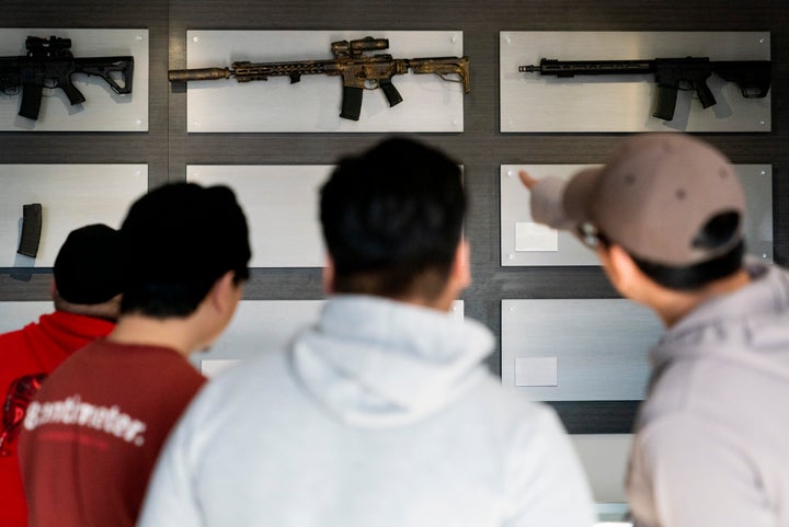 Customers look at AR-15-style rifles on a mostly empty display wall at Rainier Arms Friday, April 14, 2023, in Auburn, Wash. as stock dwindles before potential legislation that would ban future sale of the weapons in the state. House Bill 1240 would ban the future sale, manufacture and import of assault-style semi-automatic weapons to Washington State and would go into immediate effect after being signed by Gov. Jay Inslee.