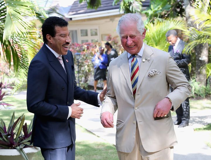 The then-Prince of Wales speaks with singer Lionel Ritchie at a Prince's Trust reception on March 19, 2019, in Bridgetown, Barbados.