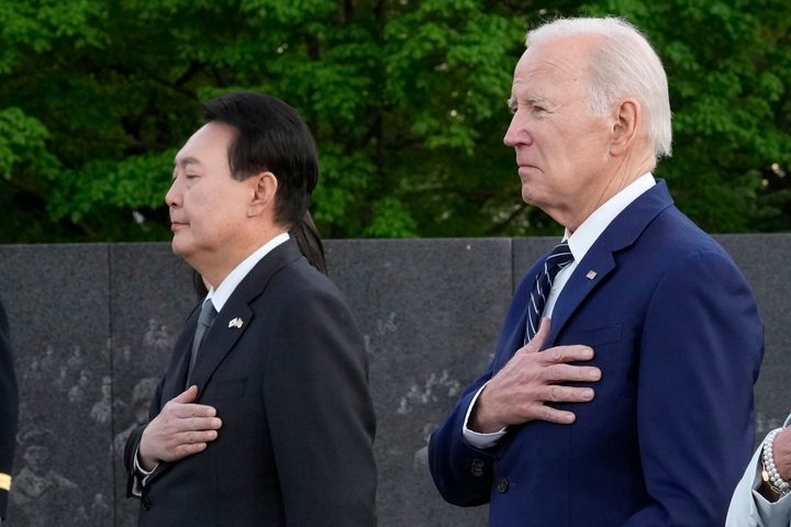 President Joe Biden and South Korea's President Yoon Suk Yeol pause after laying a wreath as they visit the Korean War Veterans Memorial in Washington, on April 25, 2023. 