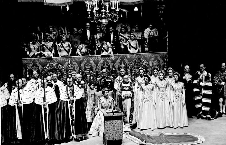 File photo dated 02/06/53 of Prince Charles, standing between the Queen Mother and Princess Margaret, disappearing for a moment behind the canopied stand. Prince Charles became the first child in British history to witness their mother's coronation as sovereign when he attended Queen Elizabeth II's 1953 ceremony at the age of just four.