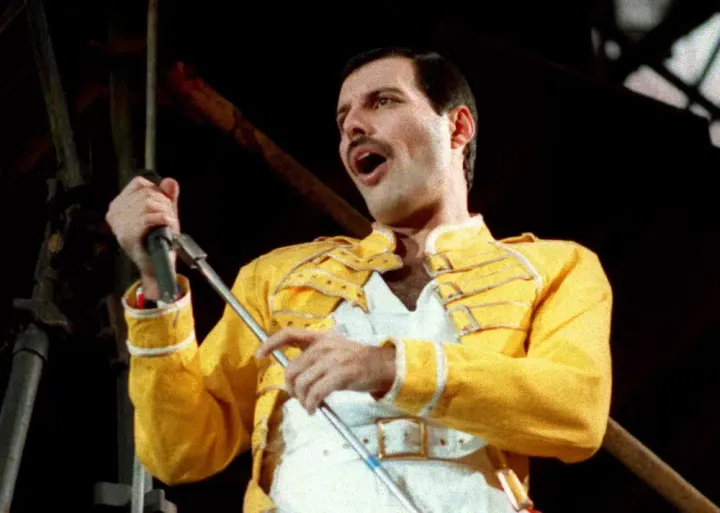 Freddie Mercury performs in Cologne, Germany, on July 20, 1986. Mercury's extensive collection of costumes, fine art, and even handwritten working lyrics to “We Are the Champions” will be auctioned in Sept. 2023.