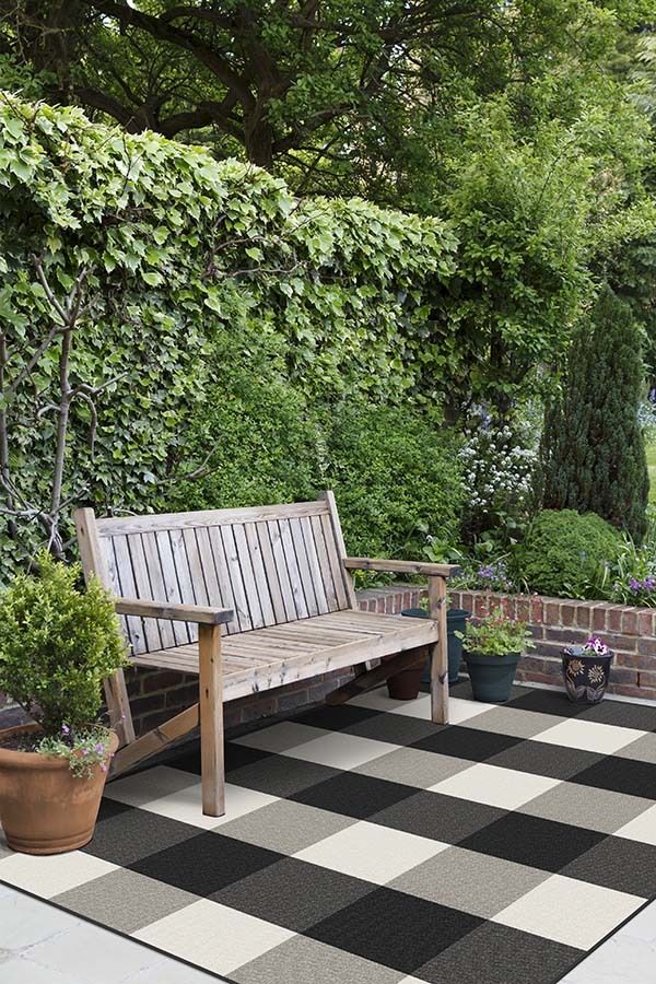 Try a chic checkered outdoor rug to bring living room vibes outside