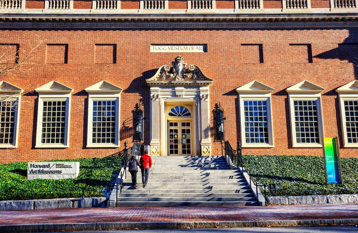 Cambridge, Massachusetts, USA - December 13, 2022: Two people walking up the steps to the Fogg Museum of Art in the Harvard Art Museum's historic building (c. 1925).