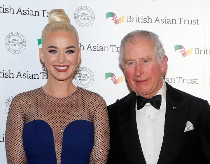 Perry and then-Prince Charles, royal founding patron of the British Asian Trust, pose together as they arrive at a reception for supporters of the British Asian Trust on Feb. 4, 2020, in London.