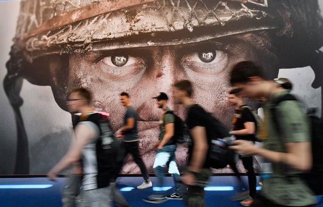 People passing an advertisement for the video game Call of Duty.