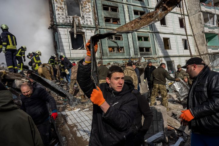 Following a Russian attack, first responders remove rubble at a residential building in Uman, central Ukraine, on April 28, 2023.