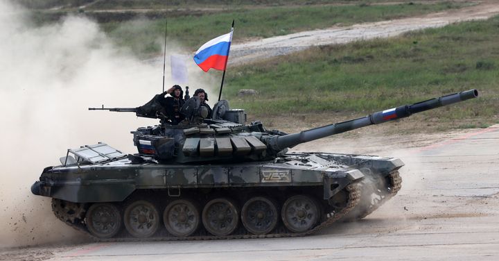 Russian team members on a T-72 B3 battle tank salute during the finals of the tank biathlon last year's games in Alabino, outside of Moscow.