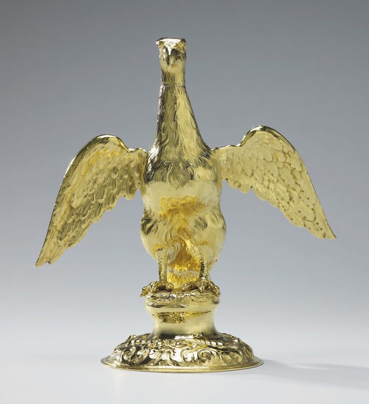 An eagle holds the coronation oil.