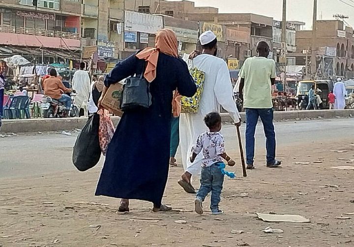 Σουδανοί έξω από το Χαρτούμ τρέχουν, έχοντας μαζί τους τα απολύτως απαραίτητα, για να προλάβουν ένα φορτηγό που θα τους απομακρύνει από την πόλη 