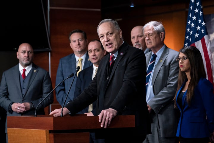 FILE - Rep. Andy Biggs, R-Ariz., center, speaks as members of the House Freedom Caucus hold a news conference at the Capitol in Washington, Friday, March 10, 2023. The banishment of transgender lawmaker Zooey Zephyr from Montana's House floor has showcased the rising power of hardline conservatives who are leveraging divisive social issues to gain political influence. From left are Rep. Clay Higgins, R-La., Rep. Michael Cloud, R-Fla., Rep. Bob Good, R-Va., Rep. Andy Biggs, R-Ariz., Rep. Chip Roy, R-Texas, Rep. Ralph Norman, R-S.C., and Rep. Lauren Boebert, R-Colo. (AP Photo/J. Scott Applewhite, File)