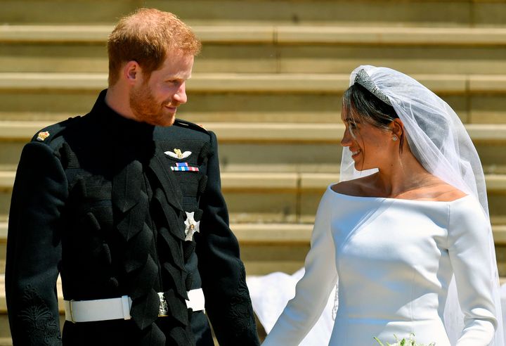 FILE - Prince Harry and Meghan Markle walk down the steps after their wedding at St. George's Chapel in Windsor Castle in Windsor, near London, England, Saturday, May 19, 2018. Britain’s monarchy is bracing for more bombshells to be lobbed over the palace gates Thursday, Dec. 8, 2022 as Netflix releases the first three episodes of a series that promises to tell the “full truth” about Prince Harry and Meghan’s estrangement from the royal family. (Ben Birchhall/pool photo via AP, file)