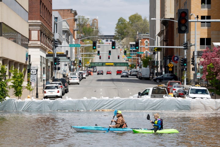 A group of kayakers paddle along River Drive along the HESCO sand barriers protecting downtown from the rising Mississippi River in Davenport, Iowa on Saturday. The city of Dubuque has closed its floodgates for only the third time ever in response to flooding. Further south in the Quad Cities — five adjoining cities along the river in Iowa and Illinois — the river is expected to crest at 21.6 feet (6.6 meters) Monday. 