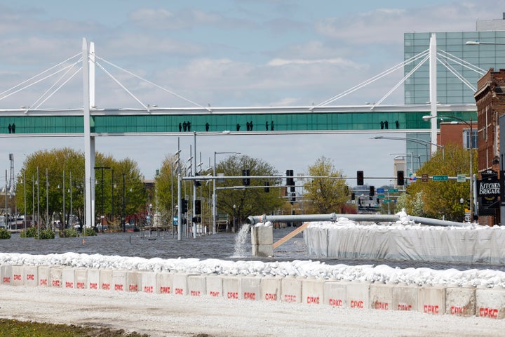 A look down River Drive as the Mississippi River flows through downtown Davenport, Iowa on Saturday. The Upper Mississippi River will rise to near record-high levels as it flows through Wisconsin and Iowa.