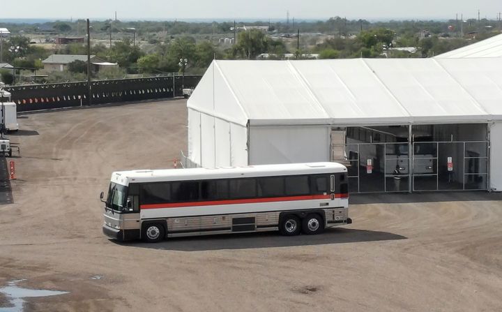 A bus carrying migrants departs from a U.S. Border Patrol processing facility in Eagle Pass, Texas, in October.