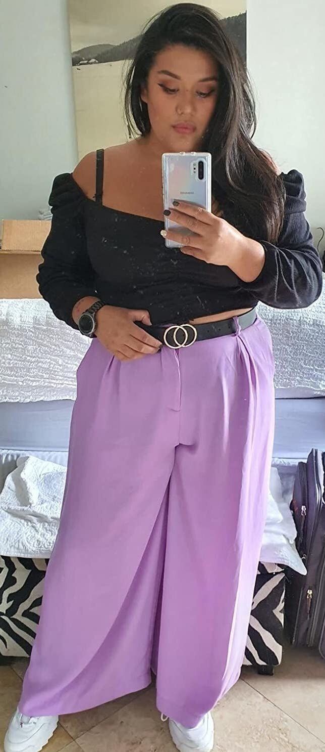 A pair of high-waisted trousers with wide legs and an elastic waistband