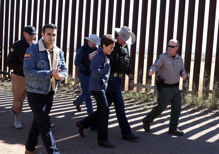 Pinal County Sheriff Mark Lamb embraces then-Arizona Republican Gubernatorial candidate Kari Lake, center, during a tour of the southern border on Nov. 4, 2022, in Sierra Vista, Arizona.