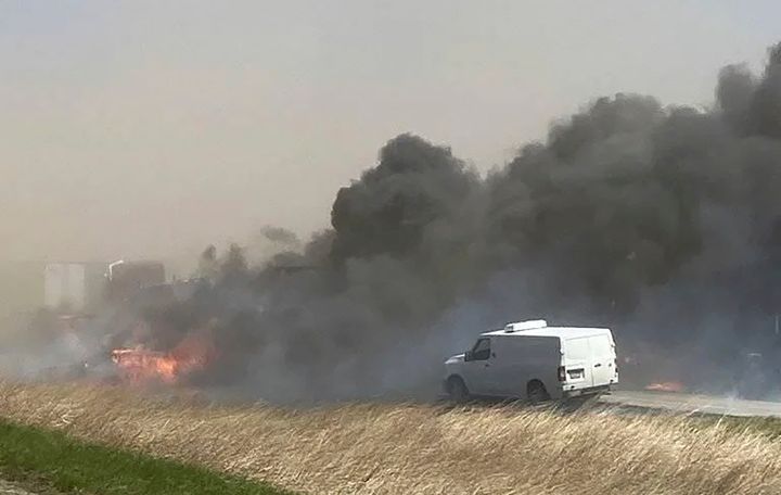 Smoke billows after a crash involving at least 20 vehicles shut down a highway in Illinois, Monday, May 1, 2023. (WICS TV via AP)