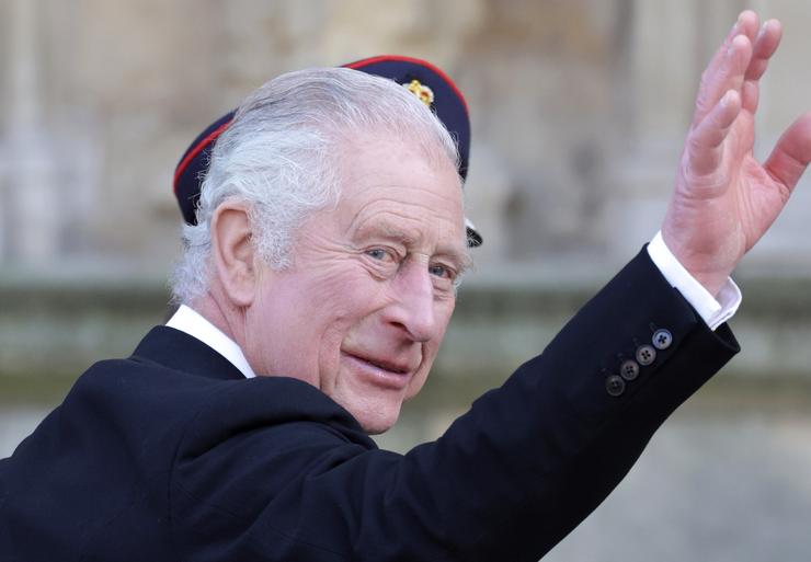 King Charles III waves to spectators as he and Queen Consort Camilla attend the Royal Maundy service on April 6, 2023, in York, England. 
