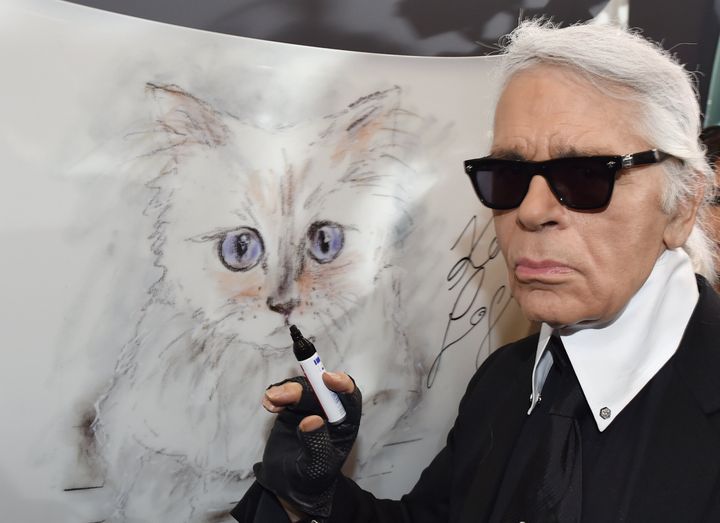 Karl Lagerfeld signs a photo of his cat Choupette in 2015