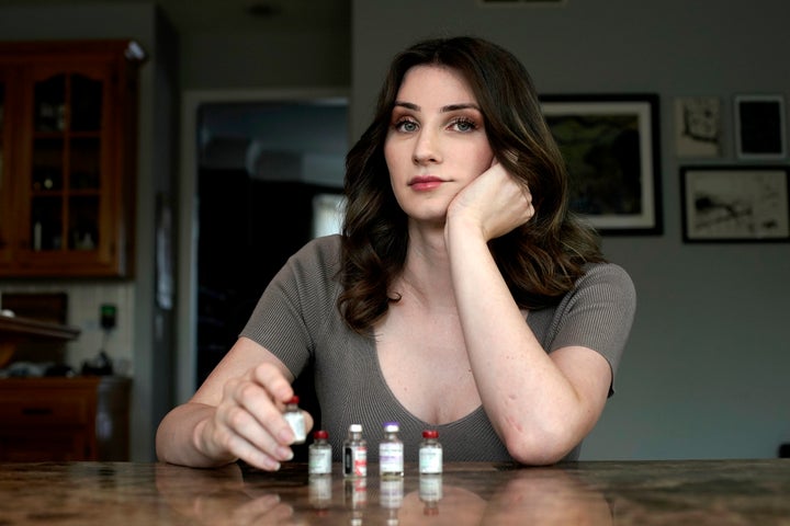 Transgender woman Stacy Cay displays some of the hormone therapy drugs she has stockpiled in fear of losing her supply, on April 20, 2023, at her home in Overland Park, Kan. 