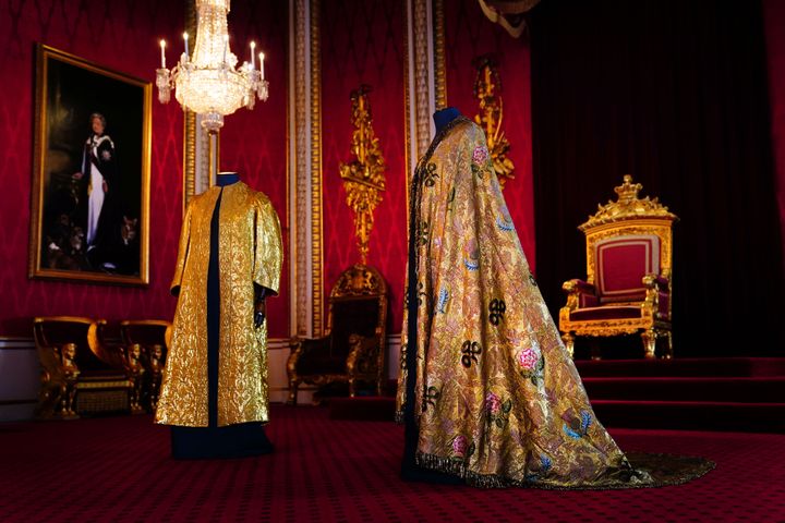 The Coronation Vestments, comprising of the Supertunica (left) and the Imperial Mantle (right), displayed in the Throne Room at Buckingham Palace