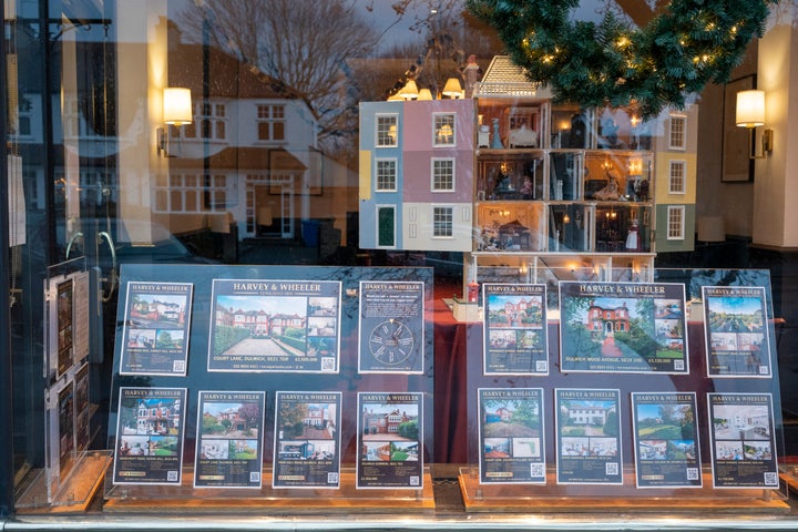 Residential properties and a dolls house are displayed in the window of Harvey & Wheeler estate agent in Dulwich Village on New Year's Eve, on 31st December 2022, in London, England. (Photo by Richard Baker / In Pictures via Getty Images)