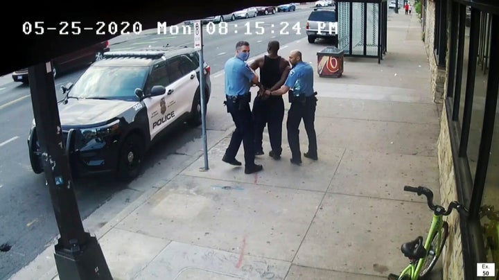 FILE - This image from video shows Minneapolis Police Officers Thomas Lane, left and J. Alexander Kueng, right, escorting George Floyd, center, to a police vehicle outside Cup Foods in Minneapolis, on May 25, 2020. 