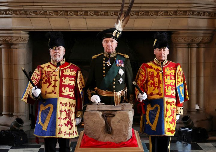 The Duke of Buccleuch (center) flanked by two Officers of Arms stand by the Stone of Destiny in Edinburgh Castle before onward transportation to Westminster Abbey for the Charles' coronation.