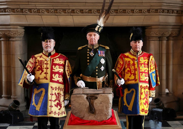 The Duke of Buccleuch (center) flanked by two Officers of Arms stand by the Stone of Destiny in Edinburgh Castle before onward transportation to Westminster Abbey for the Charles' coronation.