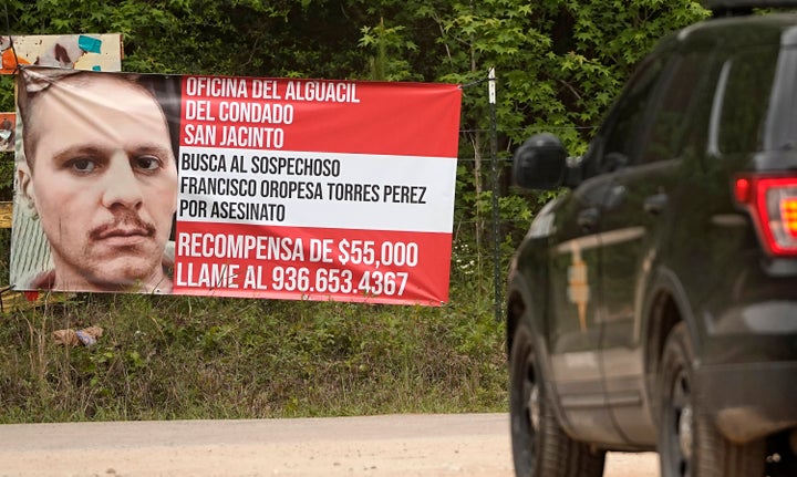 A state trooper vehicle passes a posted wanted sign for a mass shooting suspect Tuesday, May 2, 2023, in the neighborhood where the shooting occurred Friday, in Cleveland, Texas.