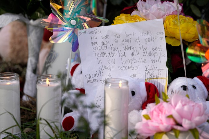 A letter sits among items left by neighbors during a vigil, Monday, May 1, 2023, outside the home where a mass shooting occurred Friday, in Cleveland, Texas. (AP Photo/David J. Phillip)