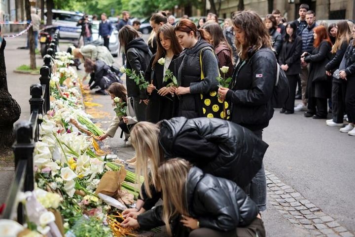 People pay tribute following a school mass shooting, after a boy opened fire on others, killing fellow students and staff in Belgrade, Serbia, May 4, 2023. REUTERS/Antonio Bronic