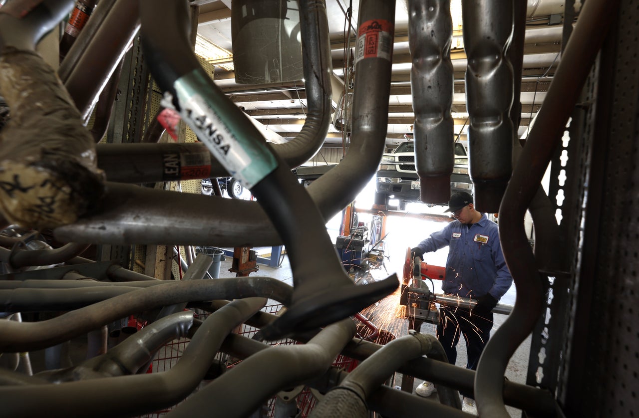 Luis Benitez cuts a pipe as he prepares to install four new catalytic converters onto a Chevrolet Silverado at Johnny Franklin's Muffler on July 11, 2022 in San Rafael, California. 