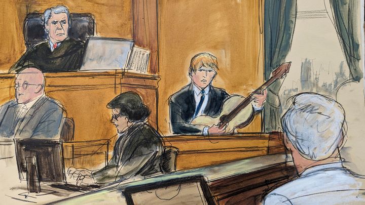 Ed Sheeran plays his guitar on the witness stand during his testimony with Judge Louis Stanton presiding, Monday, May 1, 2023 in Manhattan federal court. Sheeran continued testifying, Monday, to deny allegations that his hit song "Thinking Out Loud" ripped off Marvin Gaye's soul classic "Let's Get It On." (Elizabeth Williams via AP)