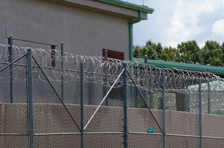 Rolls of razor wire line the top of the security fencing at the Raymond Detention Center in Raymond, Mississippi, in August 2022.