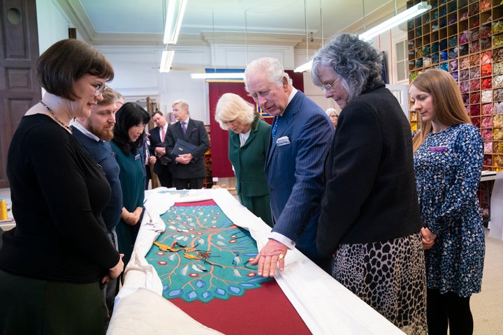 King Charles III looks at the needlework on part of the anointing screen during his visit to the Royal School of Needlework at Hampton Court Palace in London on March 21.