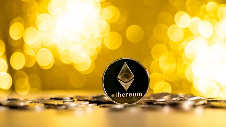 Fujian, China - December 23, 2021: Ethereum cryptocurrency on shiny background.